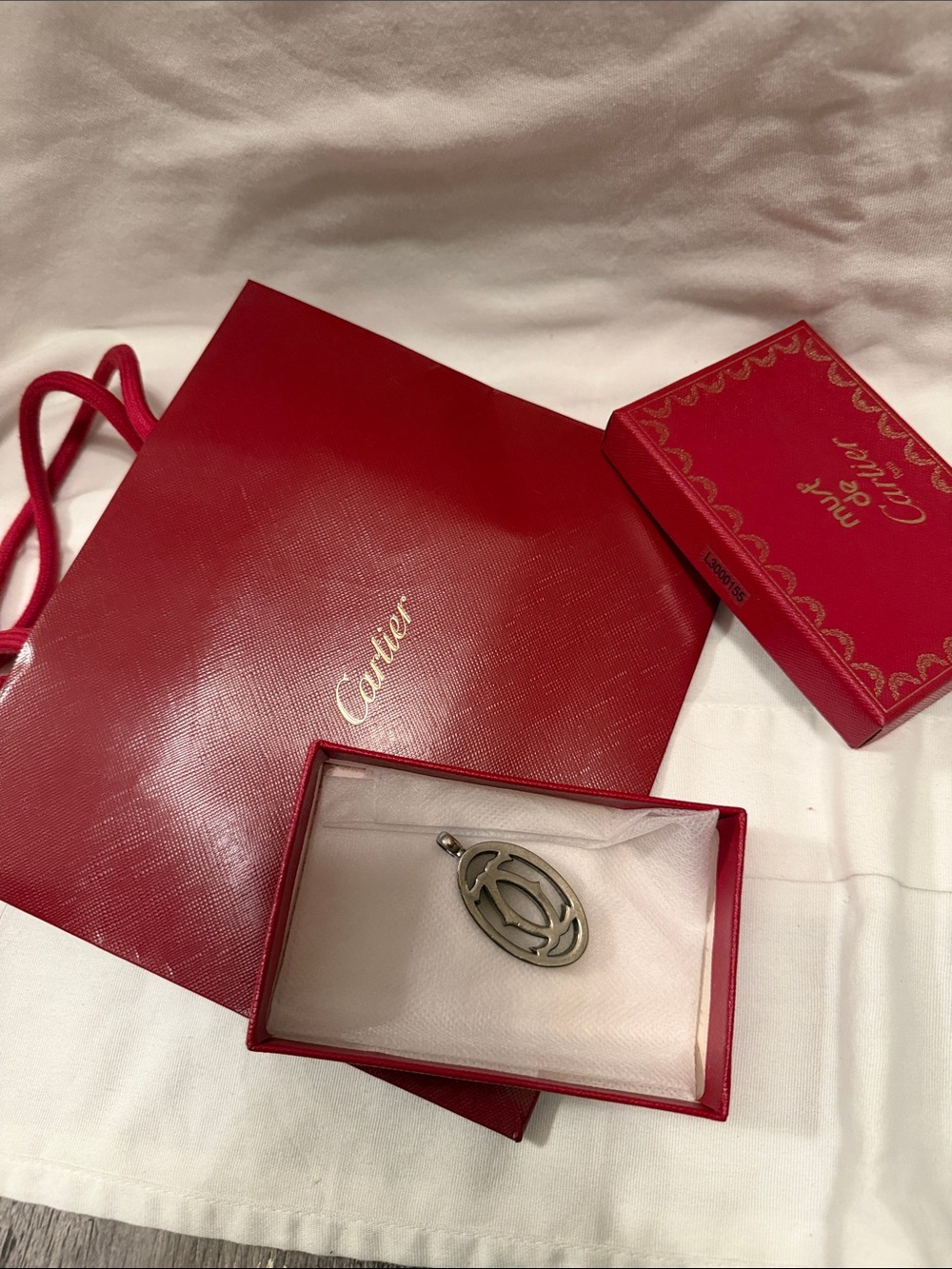 Cartier Silver Oval Logo Pendant with Red Packaging